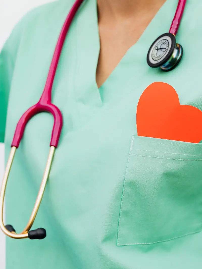 Healthcare worker with a stethoscope and a red heart in her pocket